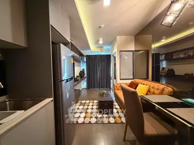 Modern living room with stylish decor and open kitchen layout in a contemporary apartment.