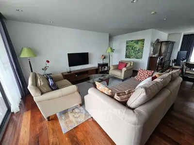 Spacious living room with elegant furniture and wooden flooring, perfect for modern living.