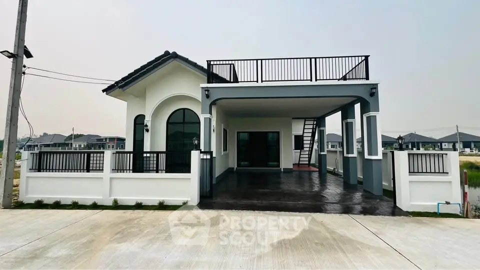 Modern single-story house with rooftop terrace and spacious driveway in a serene neighborhood.