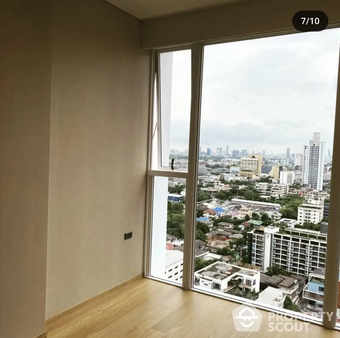 Spacious high-rise corner unit with expansive city and ocean views, featuring floor-to-ceiling windows and hardwood flooring, ready for personalization.