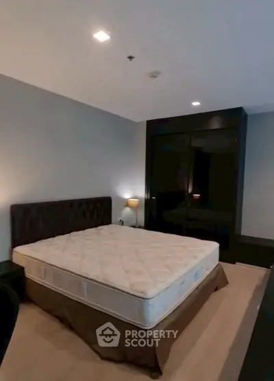 Spacious bedroom with modern furnishings and ample natural light.