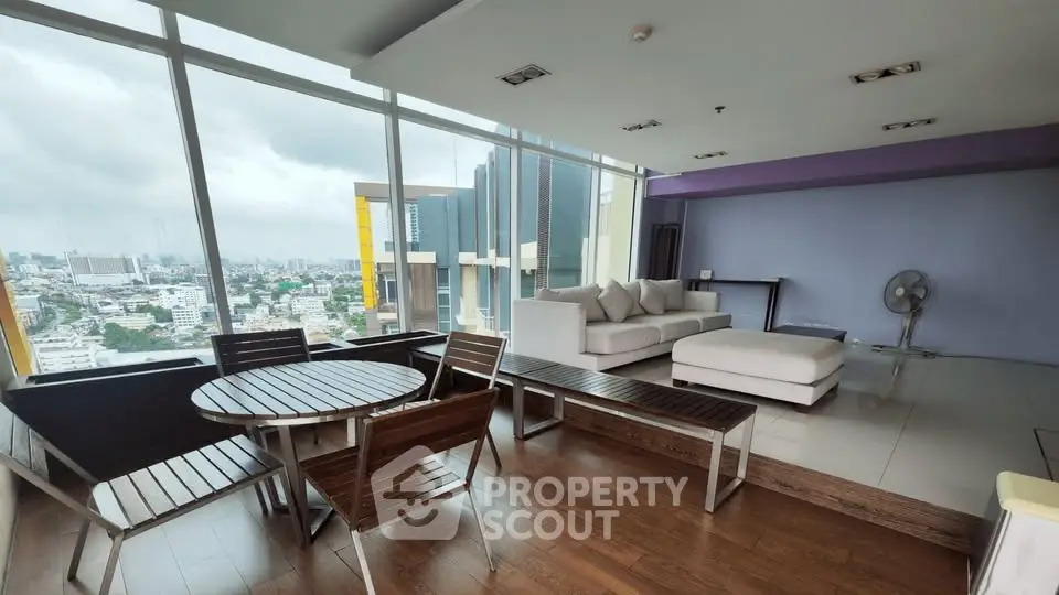 Spacious modern living room with panoramic city views and stylish furniture
