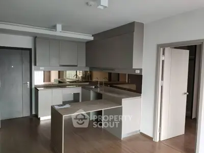 Modern kitchen with sleek cabinetry and open layout in contemporary apartment.