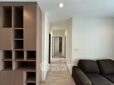 Modern apartment interior with sleek wooden shelving and cozy seating area