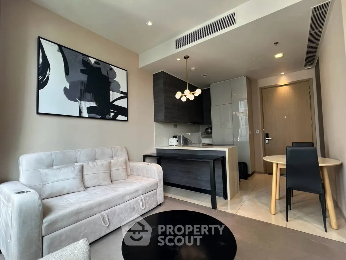 Modern living room with stylish decor and open kitchen layout in a contemporary apartment.