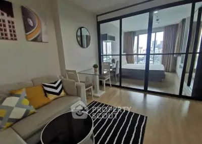 Modern apartment with stylish living room and bedroom, featuring floor-to-ceiling windows and chic decor.