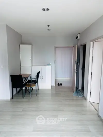 Spacious modern apartment interior with sleek flooring and minimalist design.