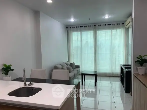 Modern living room with sleek kitchen island and cozy seating area