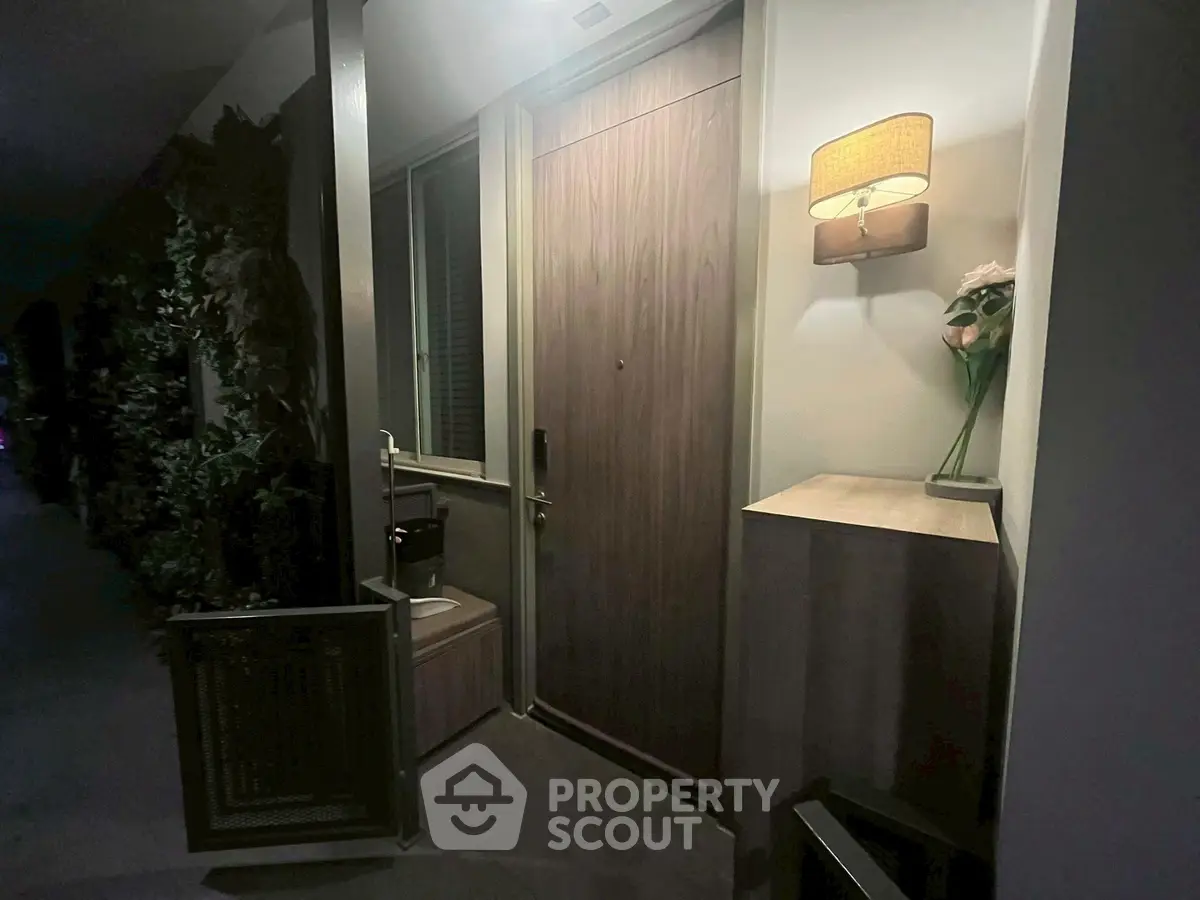 Charming apartment entrance with elegant lighting and decorative accents for a warm welcome.