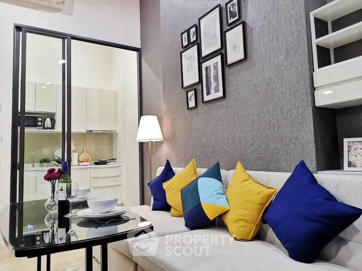 Modern living room with colorful cushions and open kitchen layout