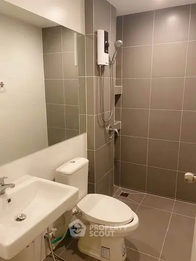 Modern bathroom with sleek tiles and contemporary fixtures in a stylish apartment.