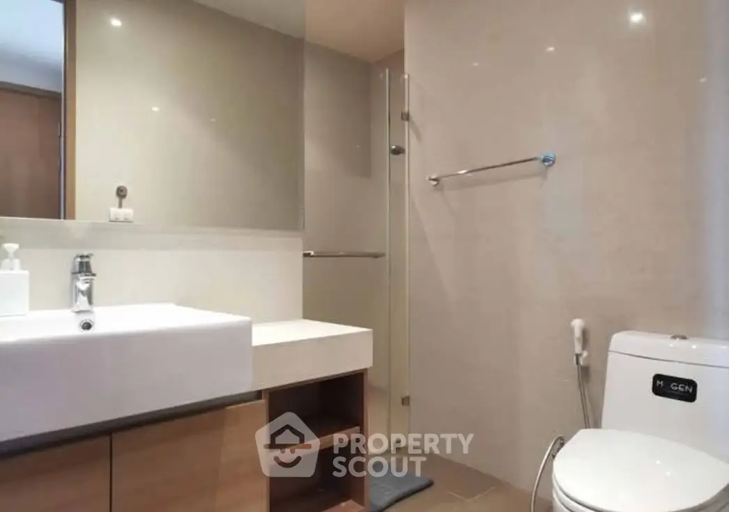 Modern bathroom with sleek fixtures and glass shower enclosure