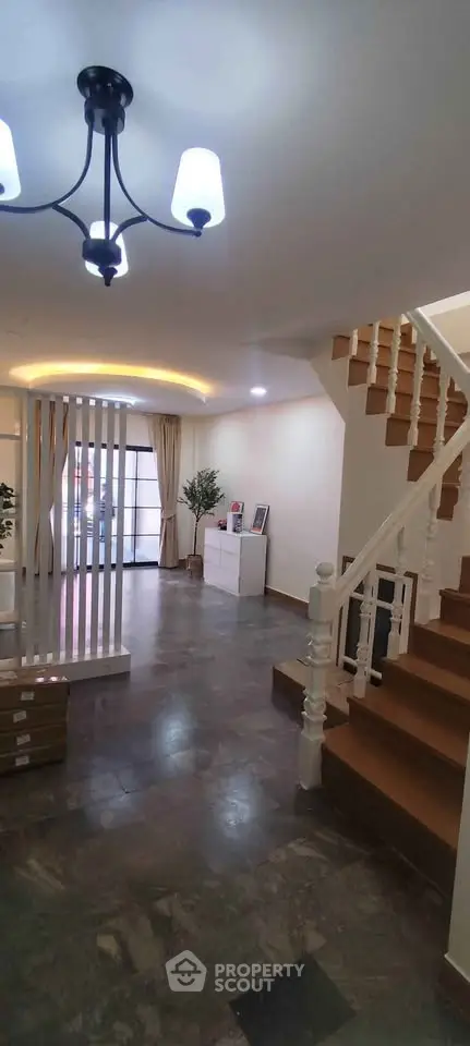 Spacious modern living room with elegant staircase and stylish lighting