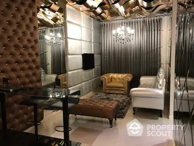 Luxurious living room with tufted leather sofas, elegant chandelier, and modern glass coffee table, perfect for upscale urban living.