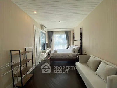 Spacious bedroom with elegant decor and natural light
