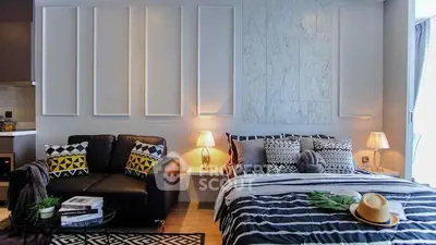 Stylish modern bedroom with cozy seating area and elegant decor