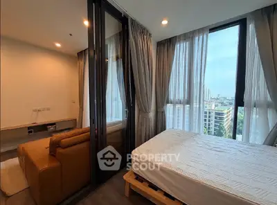 Modern bedroom with city view and glass partitioned living area