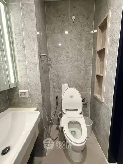 Modern bathroom with sleek design and elegant fixtures in a contemporary real estate property.
