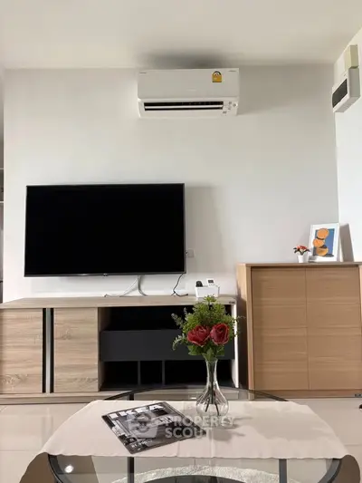 Modern living room with sleek TV setup and stylish decor, perfect for contemporary living.
