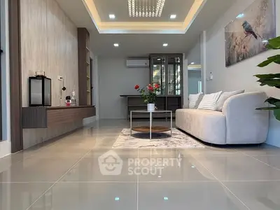 Modern living room with elegant decor and spacious layout, featuring a plush sofa and stylish lighting.