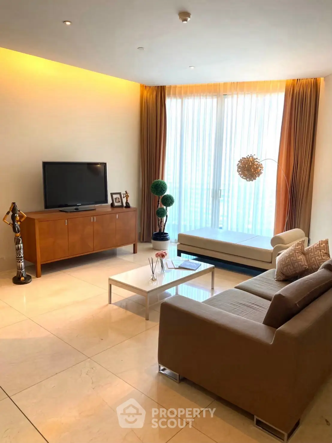 Luxurious living room with modern decor and large windows offering natural light.