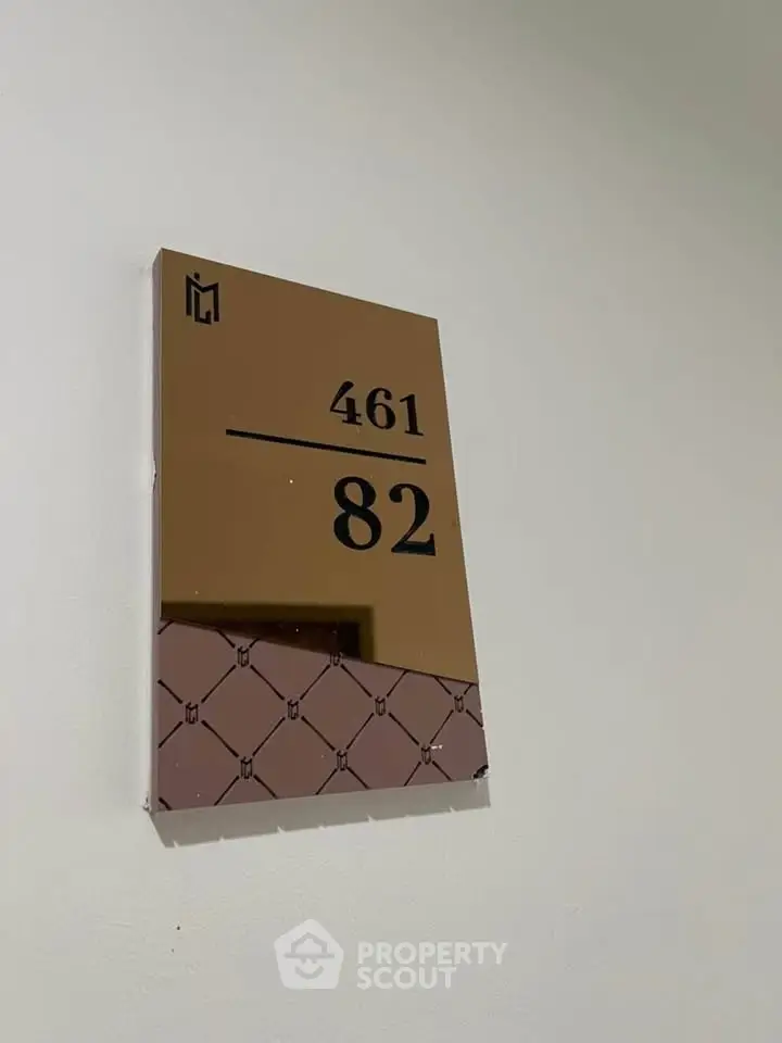 Modern apartment number plaque with stylish design and unique pattern, enhancing property appeal.