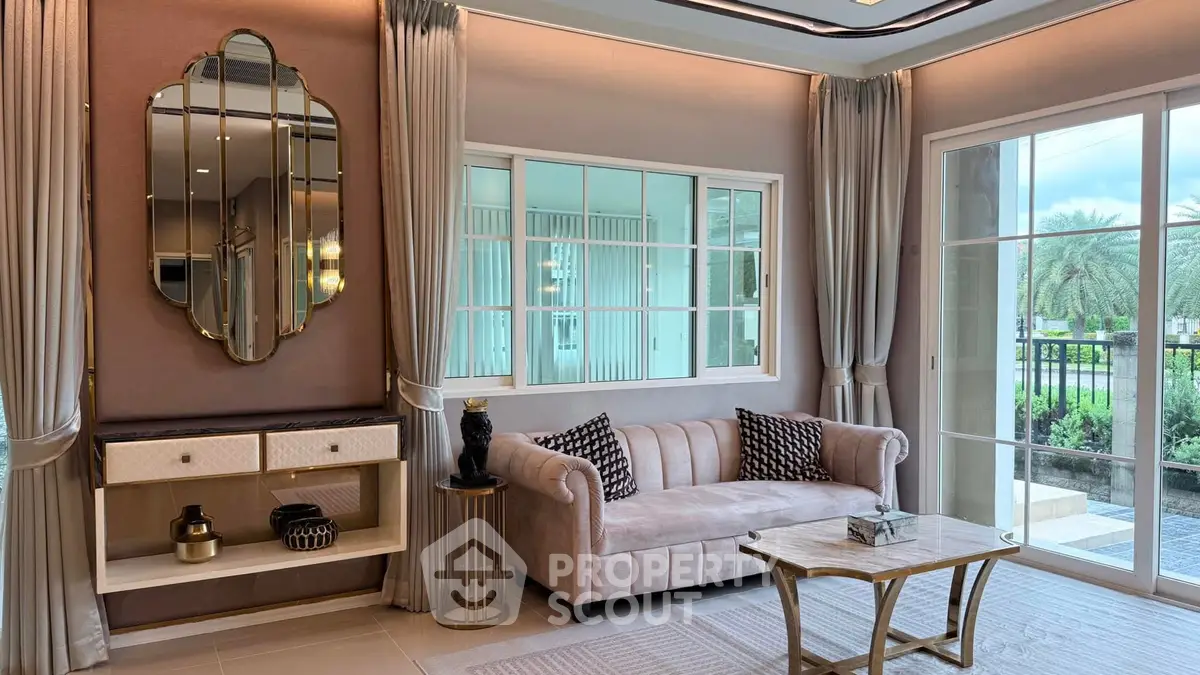 Luxurious living room with elegant decor and large windows offering garden views.