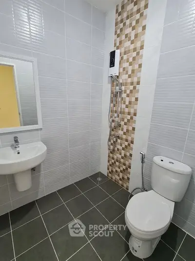 Modern bathroom with sleek tiles and compact fixtures