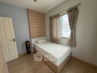 Cozy bedroom with single bed and window view, perfect for a peaceful retreat.
