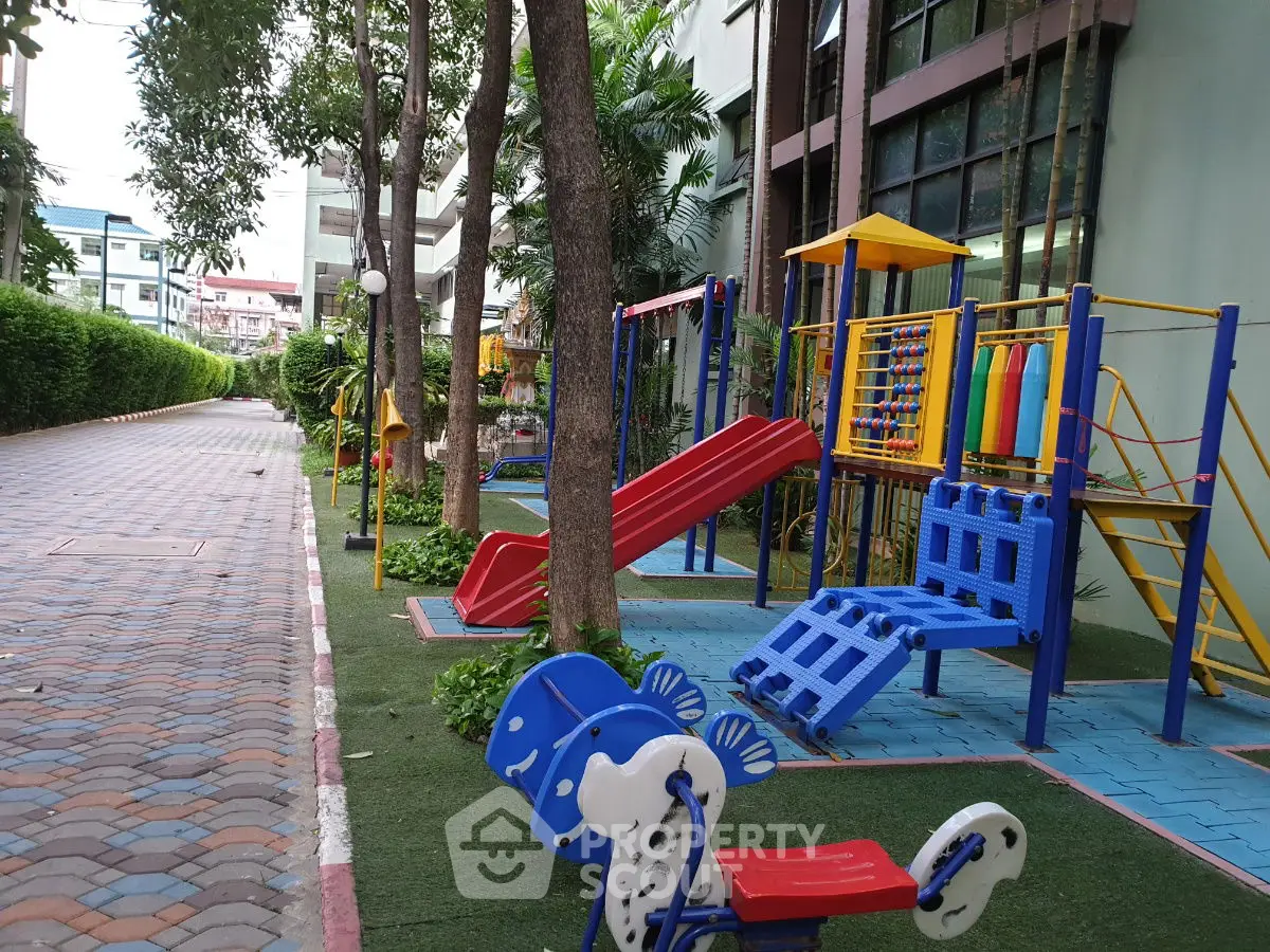 Charming residential playground with colorful slides and climbing structures.