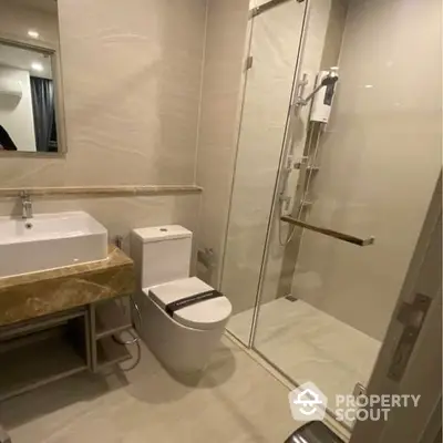 Elegant bathroom with modern fixtures, glass shower enclosure, and sleek design, perfect for a contemporary home.