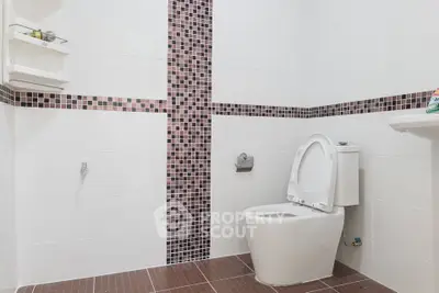 Modern bathroom with stylish tile accents and sleek fixtures.