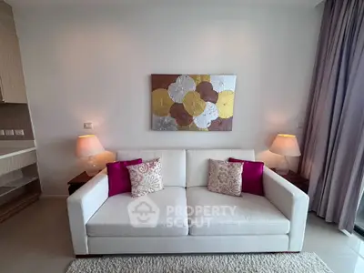 Elegant living room with modern decor and cozy white sofa, perfect for relaxation and entertaining guests.