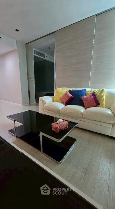 Stylish living room with modern sofa and sleek coffee table in a contemporary apartment.