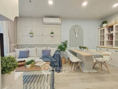 Charming living room with cozy seating and elegant dining area, featuring modern decor and soft lighting.