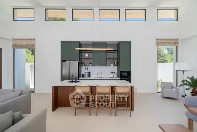 Modern open-plan kitchen with high ceilings and stylish decor