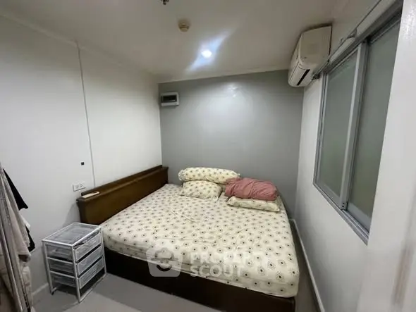 Cozy bedroom with modern air conditioning and ample natural light