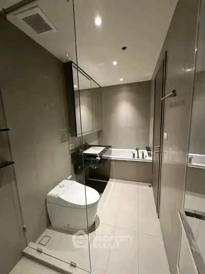 Modern bathroom with sleek design and luxurious bathtub in contemporary apartment.