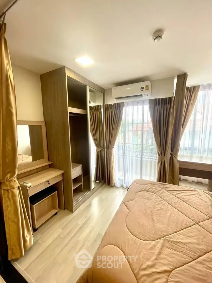 Spacious bedroom with large windows and elegant curtains, featuring a built-in wardrobe and vanity desk.