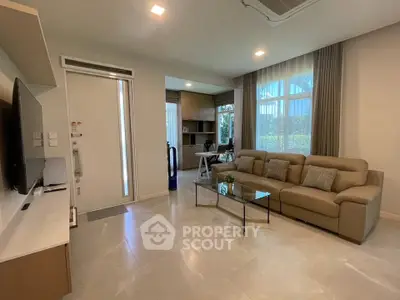 Modern living room with sleek furniture and natural light, perfect for relaxation and entertainment.