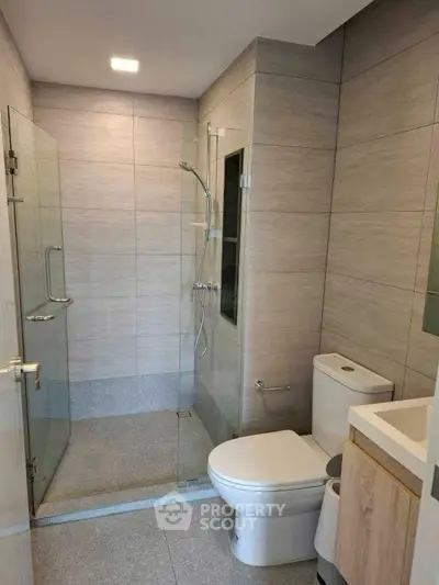 Modern bathroom with glass shower and sleek fixtures