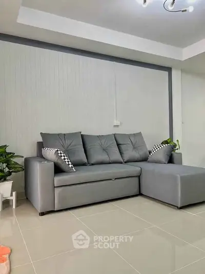 Modern living room with sleek gray sofa and stylish decor