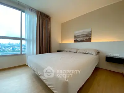 Spacious bedroom with large windows offering ample natural light and a panoramic city view, complemented by modern decor and a serene ambiance.