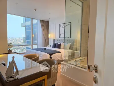 Luxurious bedroom with city view, elegant decor, and modern furnishings in high-rise apartment.