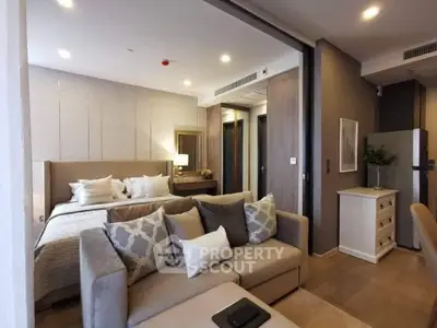 Luxurious modern bedroom with cozy living area and elegant decor