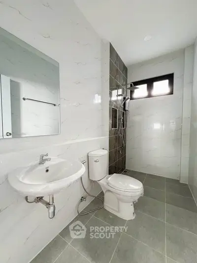 Modern bathroom with sleek fixtures and tiled shower area