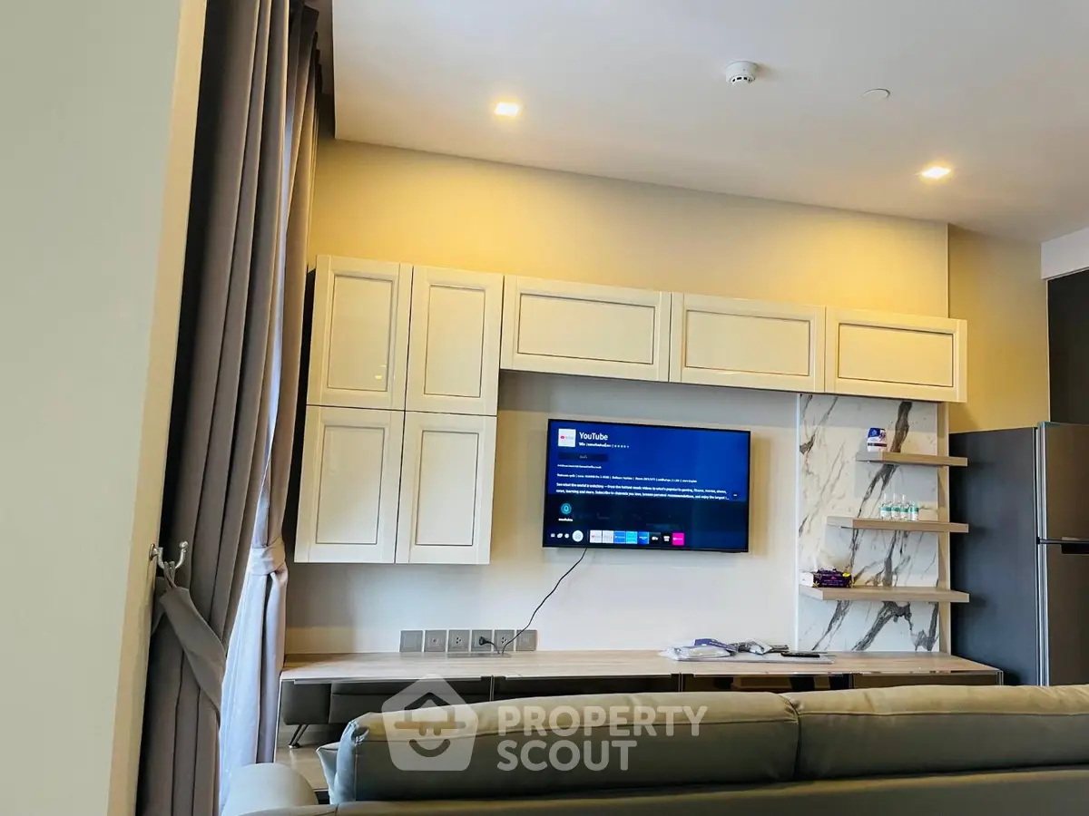 Modern living room with sleek TV setup and elegant cabinetry