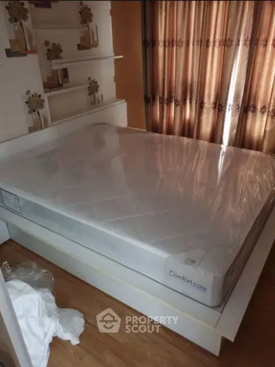Spacious bedroom with new mattress and stylish curtains
