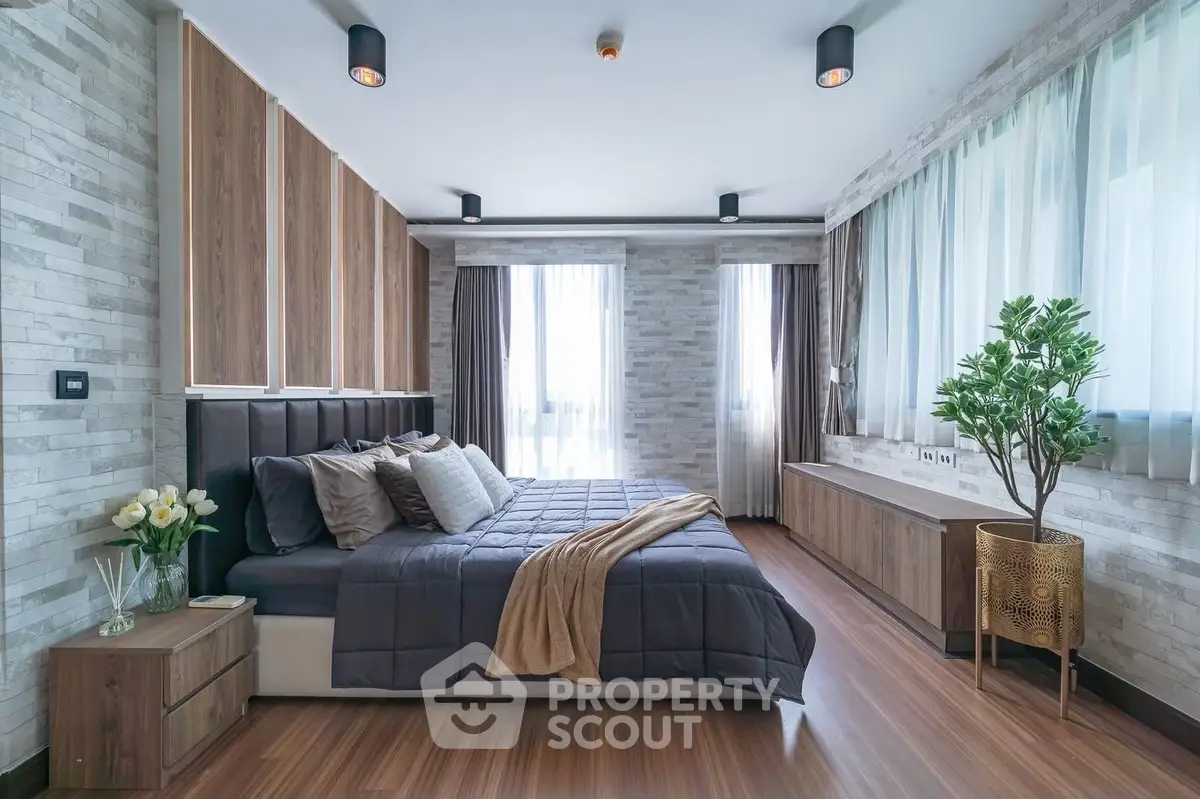 Luxurious modern bedroom with stylish decor and large windows