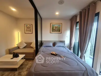 Cozy bedroom with modern decor and balcony access